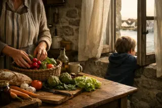 Woman arranging market produce in a rustic Morbihan island kitchen while a child looks out the window, morning light creating a serene, authentic atmosphere.